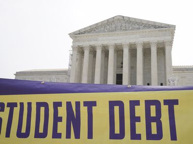 A sign reading "Student Debt" is seen outside the Supreme Court, Friday, June 30, 2023. A...