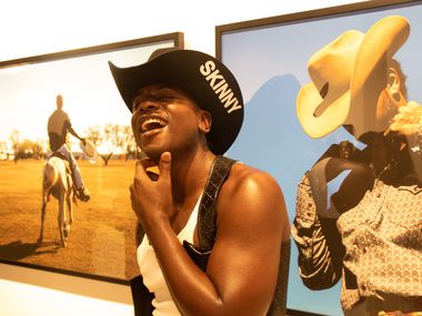 Patron Cortney Guy at Daisha Board Gallery's opening for the exhibition "Heard: Tramaine...