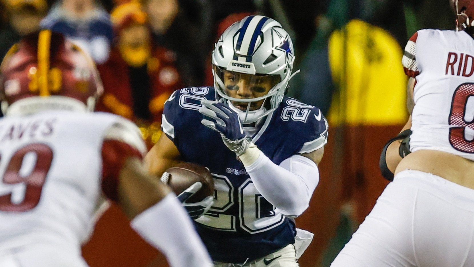 Dallas Cowboys running back Tony Pollard (20) runs with the football during the first half...